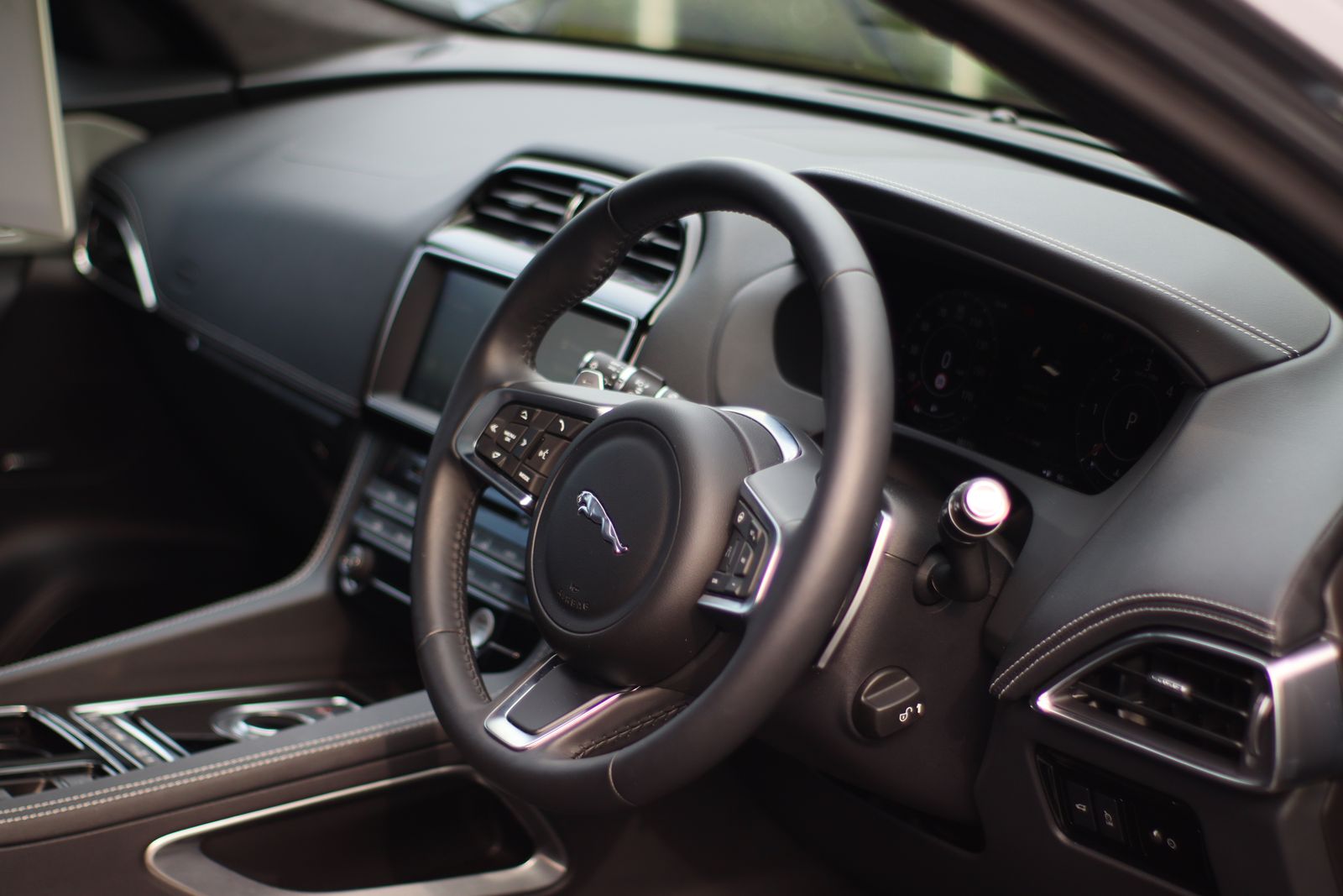 Clean luxury car dashboard and steering wheel